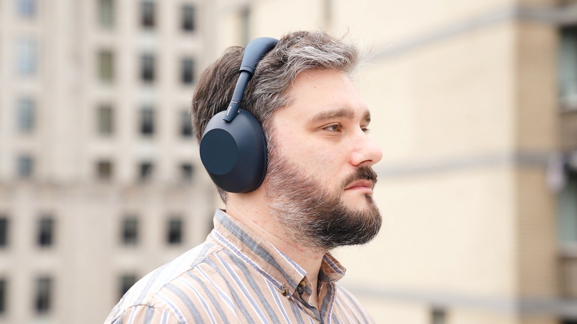 author wearing sony xm6 headphones outdoors