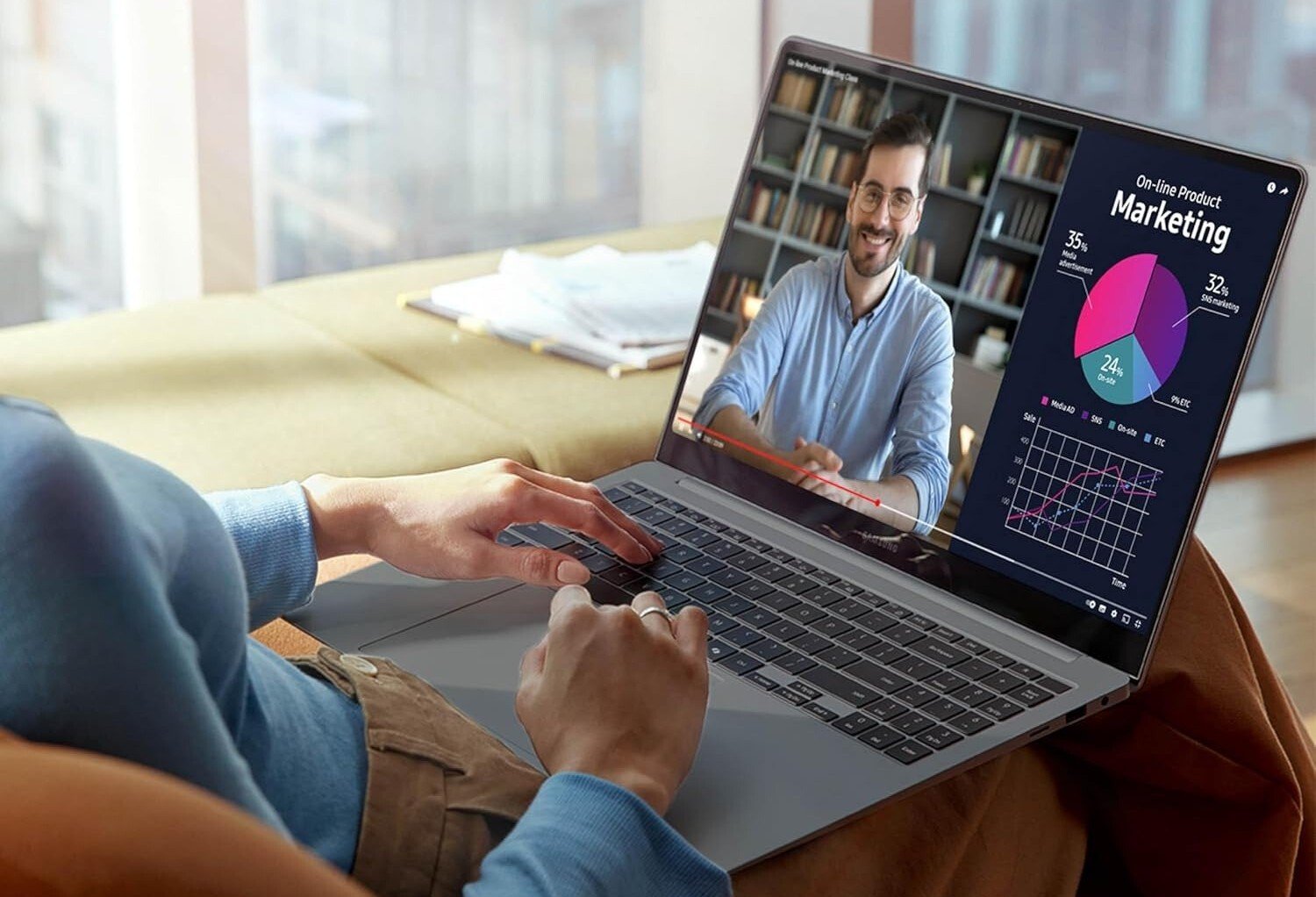 the Samsung Galaxy Book4 Pro sits on a persons lap while displaying graphs