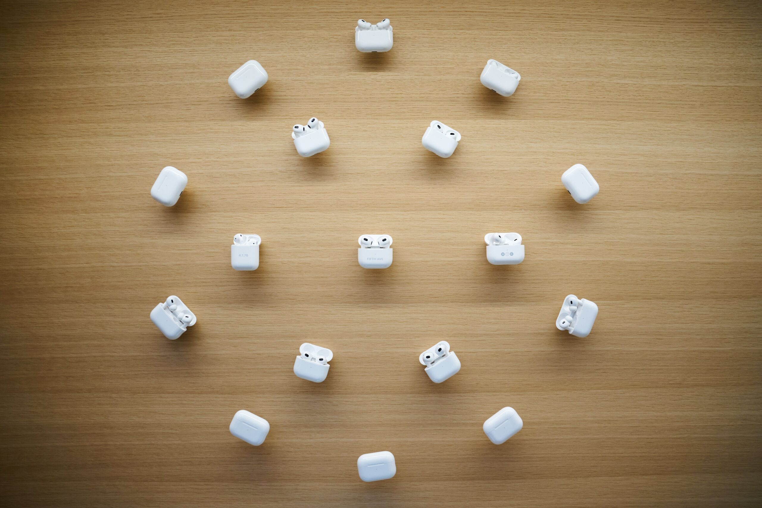 open airpod cases arranged in a cirlce