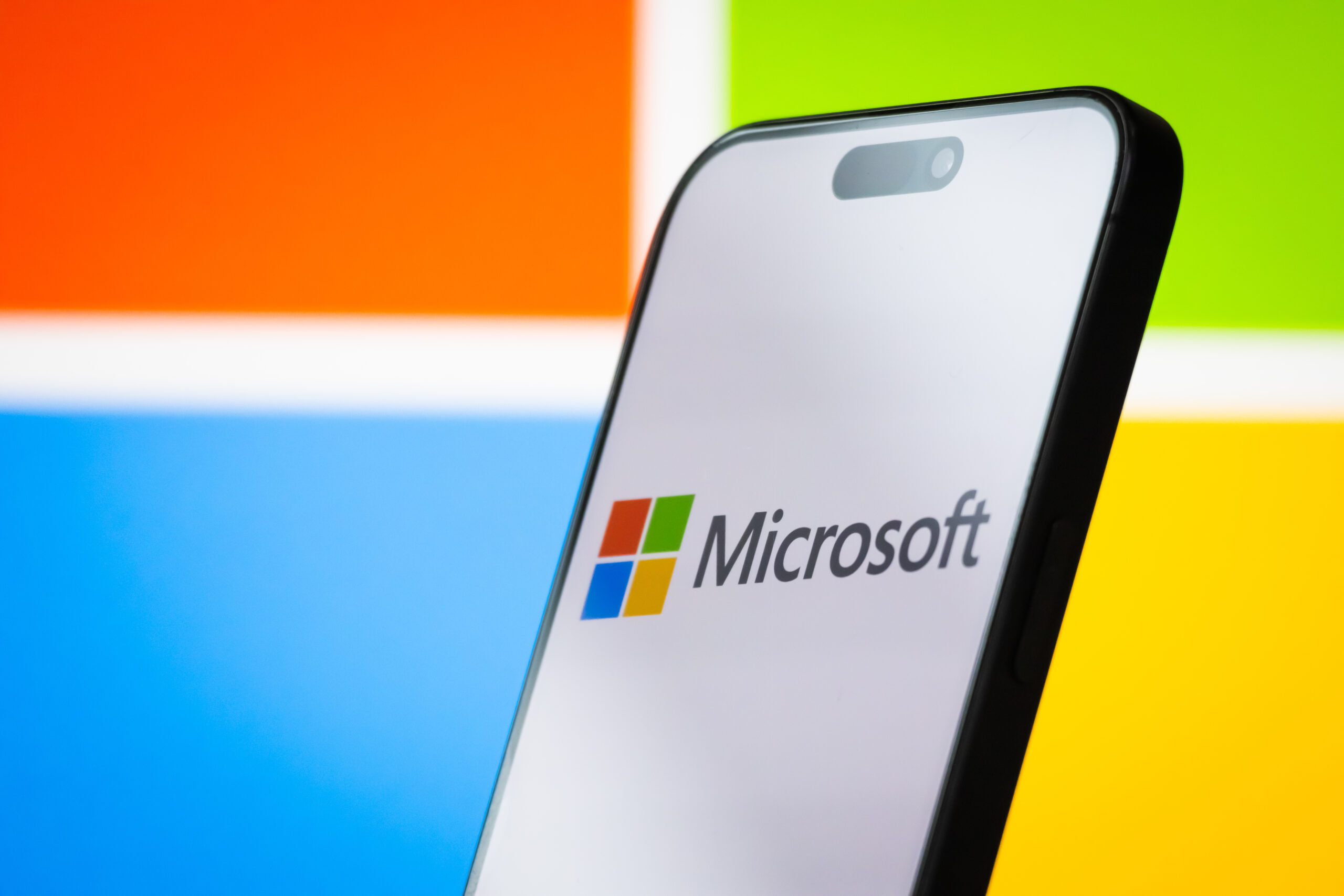 The logo of Microsoft Corporation is displayed on a smartphone screen, with the company's colorful branding visible in the background, on April 26, 2025, in Chongqing, China. Microsoft is a leading American multinational technology company, known for its Windows operating system, Microsoft Office software suite, Azure cloud services, and other enterprise and consumer technology products. 