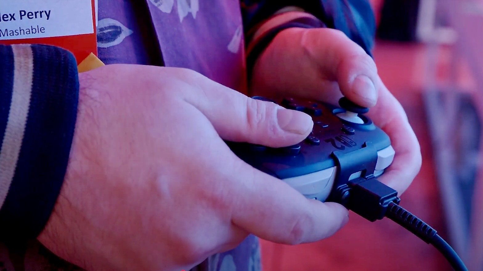 a gamer holding the switch 2 gaming console