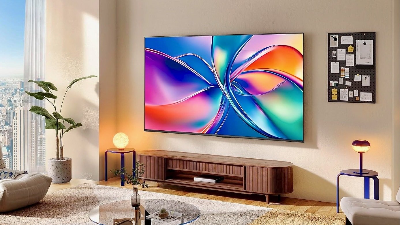 the hisense QD6 smart tv mounted on living room wall in high-rise apartment