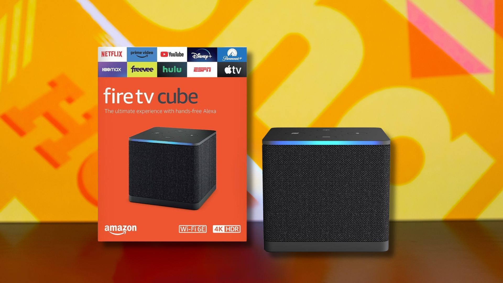 amazon fire tv cube and box against a yellow patterned background