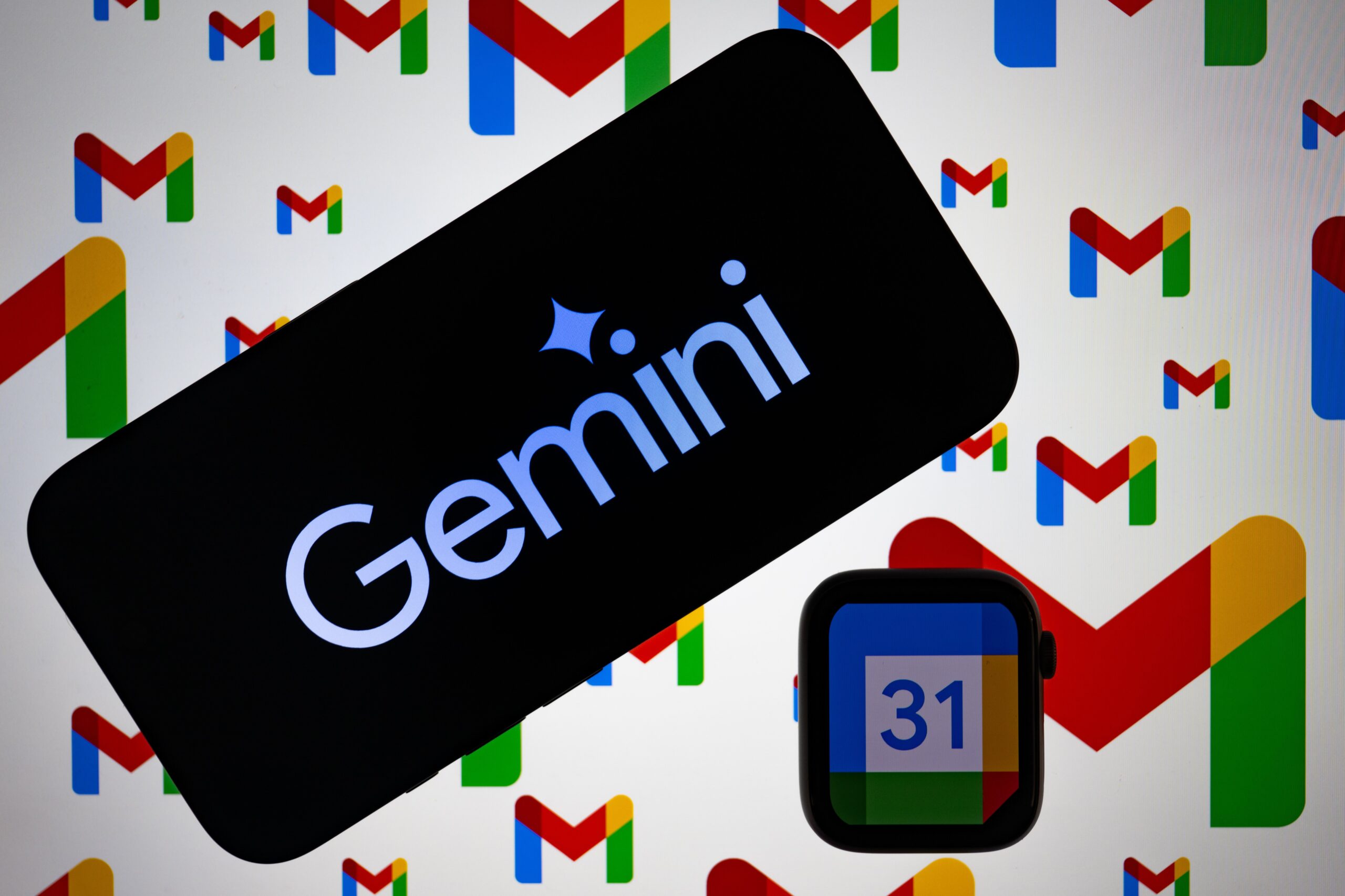 Gemini logo displayed on a mobile phone screen, in front of a background of Gmail logos