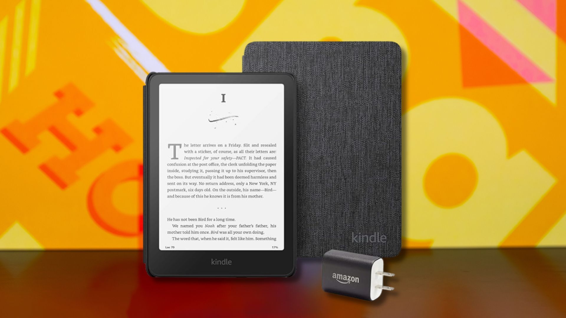 a kindle paperwhite, fabric cover, and power adapter against a yellow patterned background
