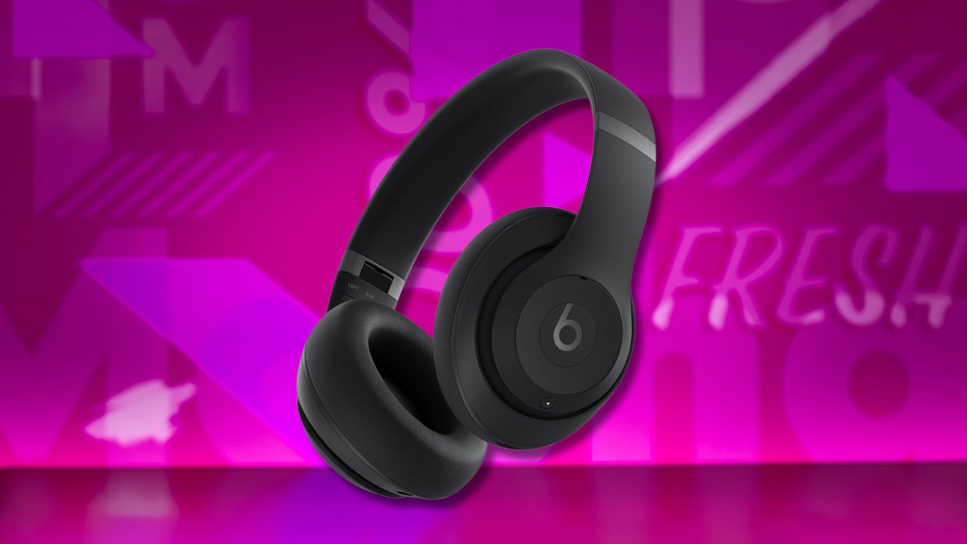 beats studio pro headphones against a pink patterned background