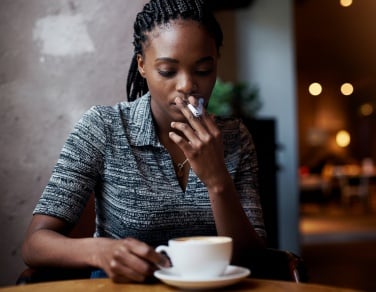 AI-generated image of woman smoking cigarette in paris cafe
