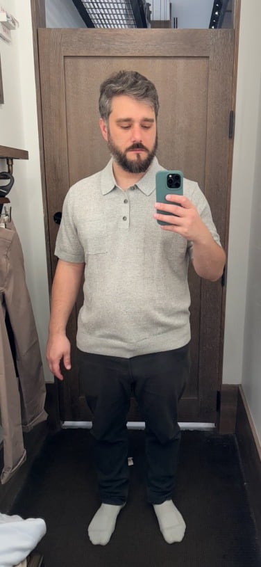 timothy beck werth, a handsome mid-30s journalist, in dressing room wearing gray polo