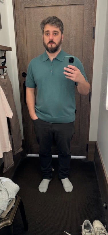 image of the author in dressing room in teal polo
