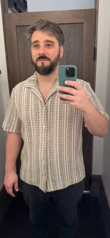 author wearing short sleeve button up in dressing room