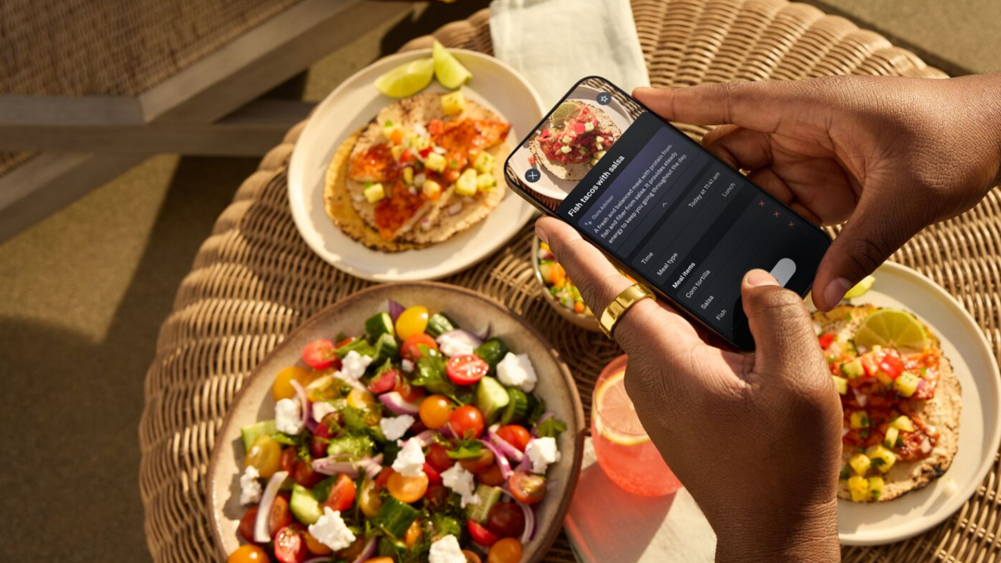 A person taking a photo of their meal in the Oura app.