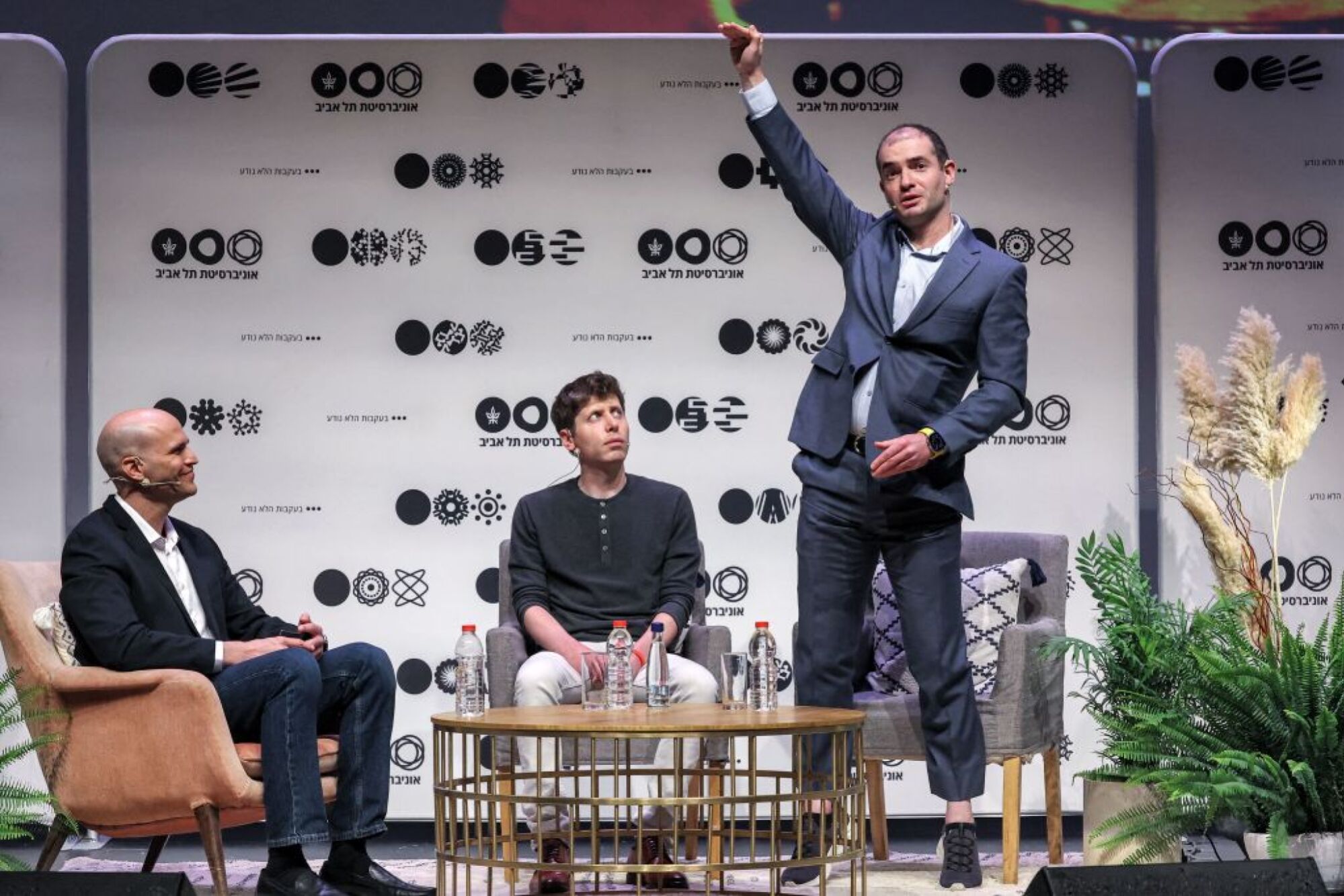 Ilya Sutskever and Sam Altman on stage at an event