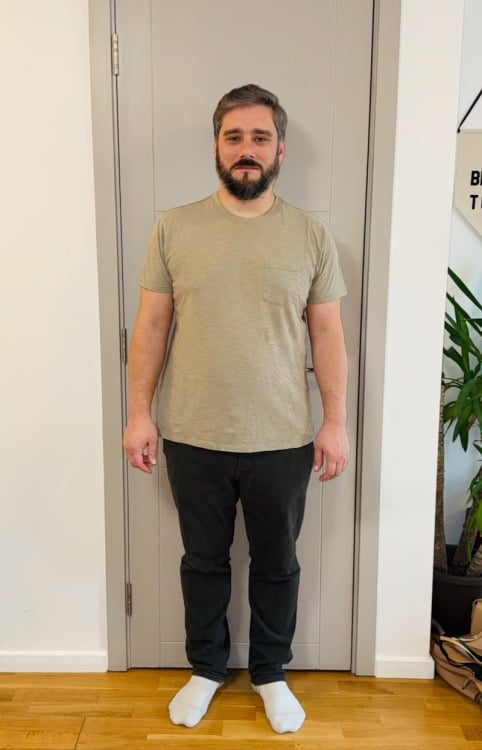the author standing in his apartment in a t-shirt