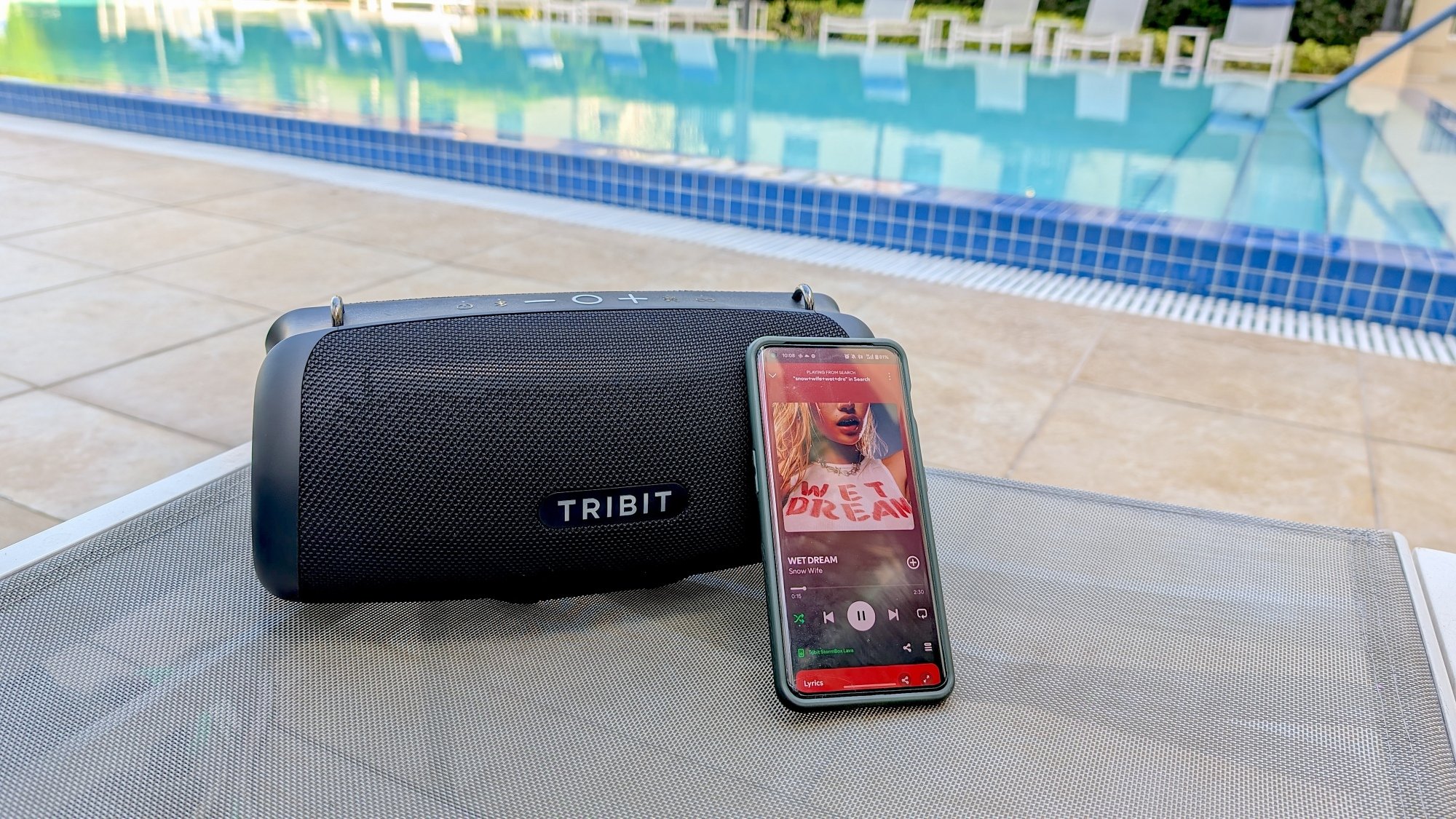 speaker next to phone with "wet dream" pulled up on Spotify