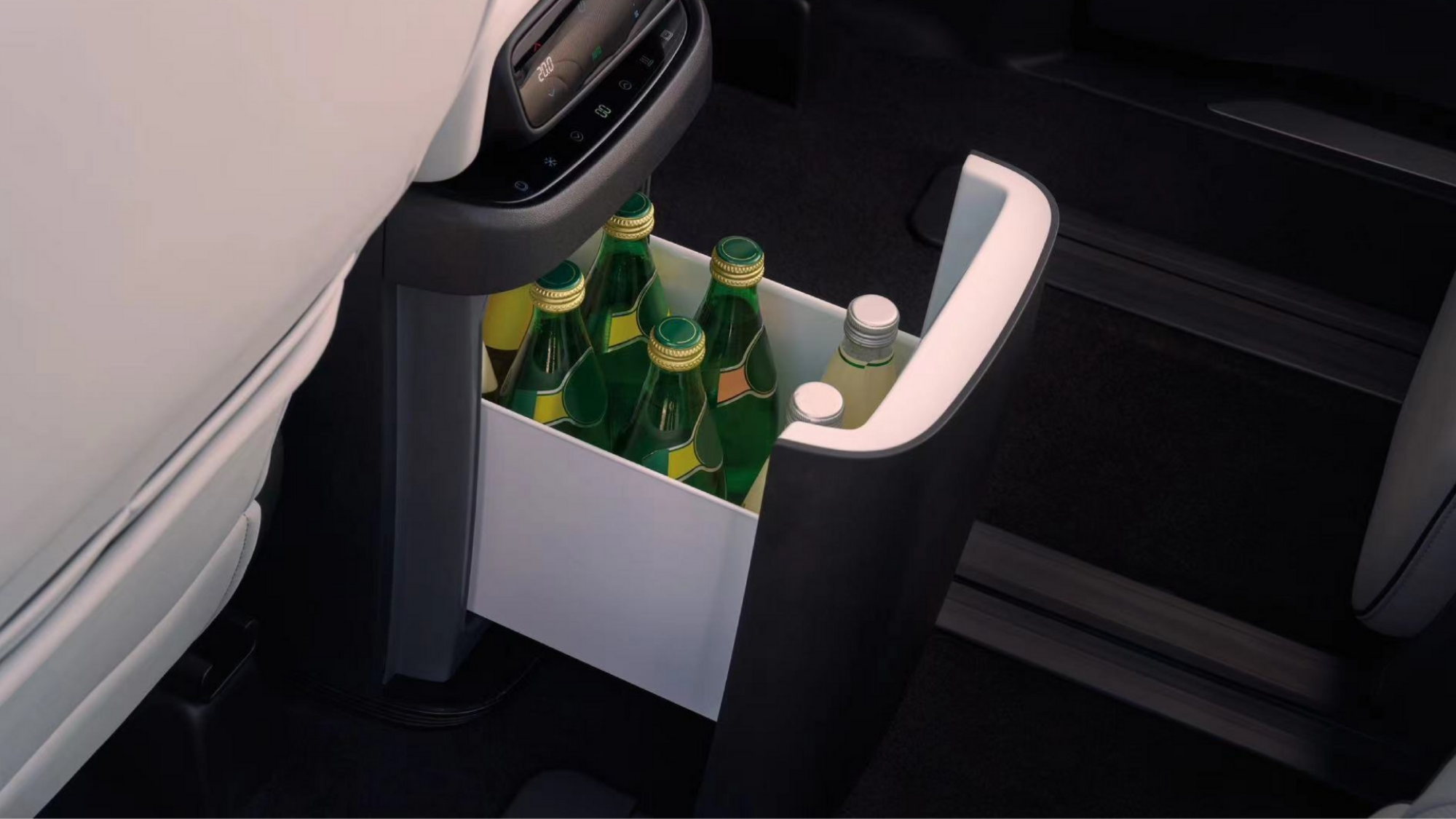 The XPENG X9's hot or cool storage compartment, open and displaying drinks.