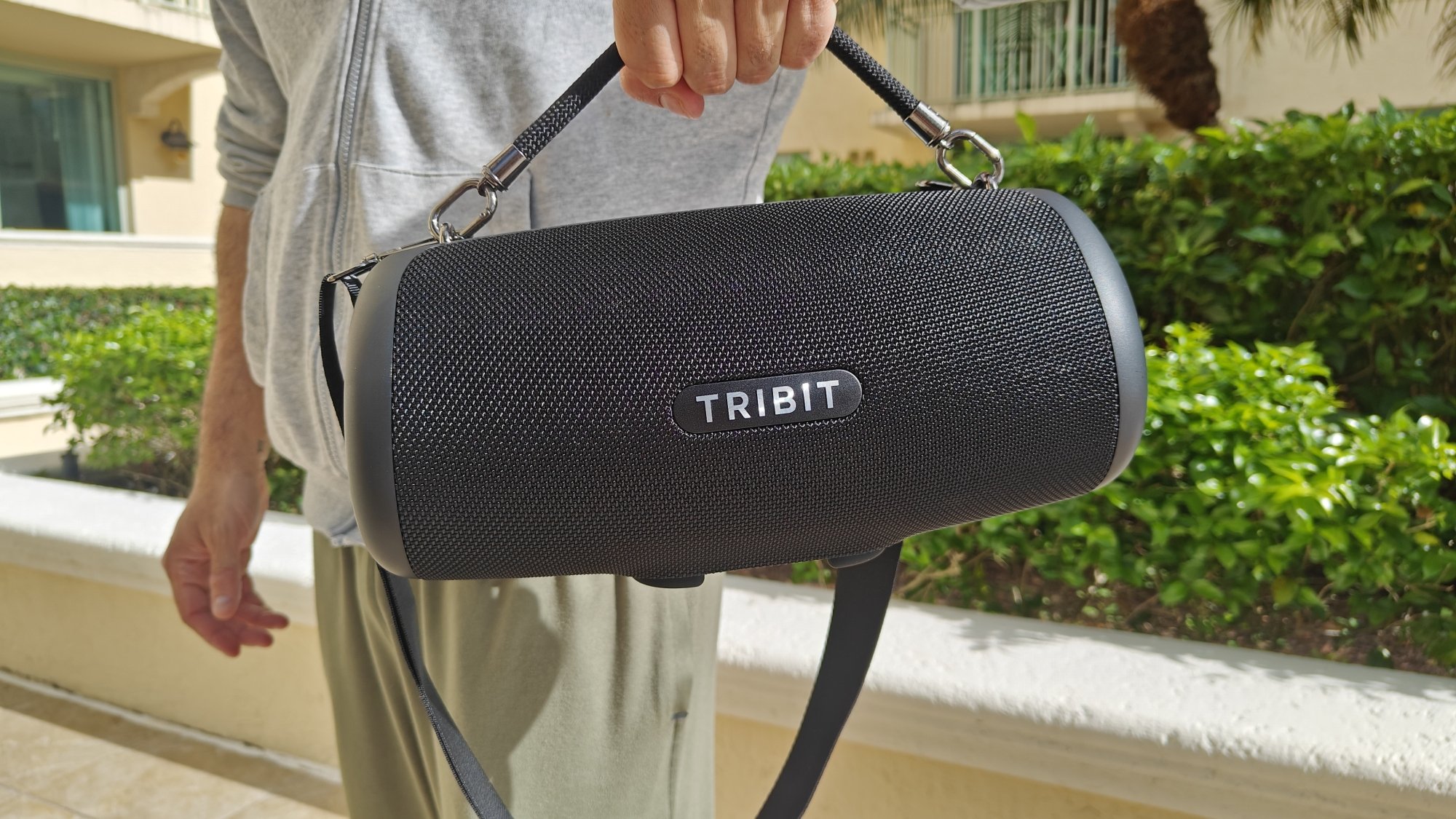 man holding tribit speaker by its handle