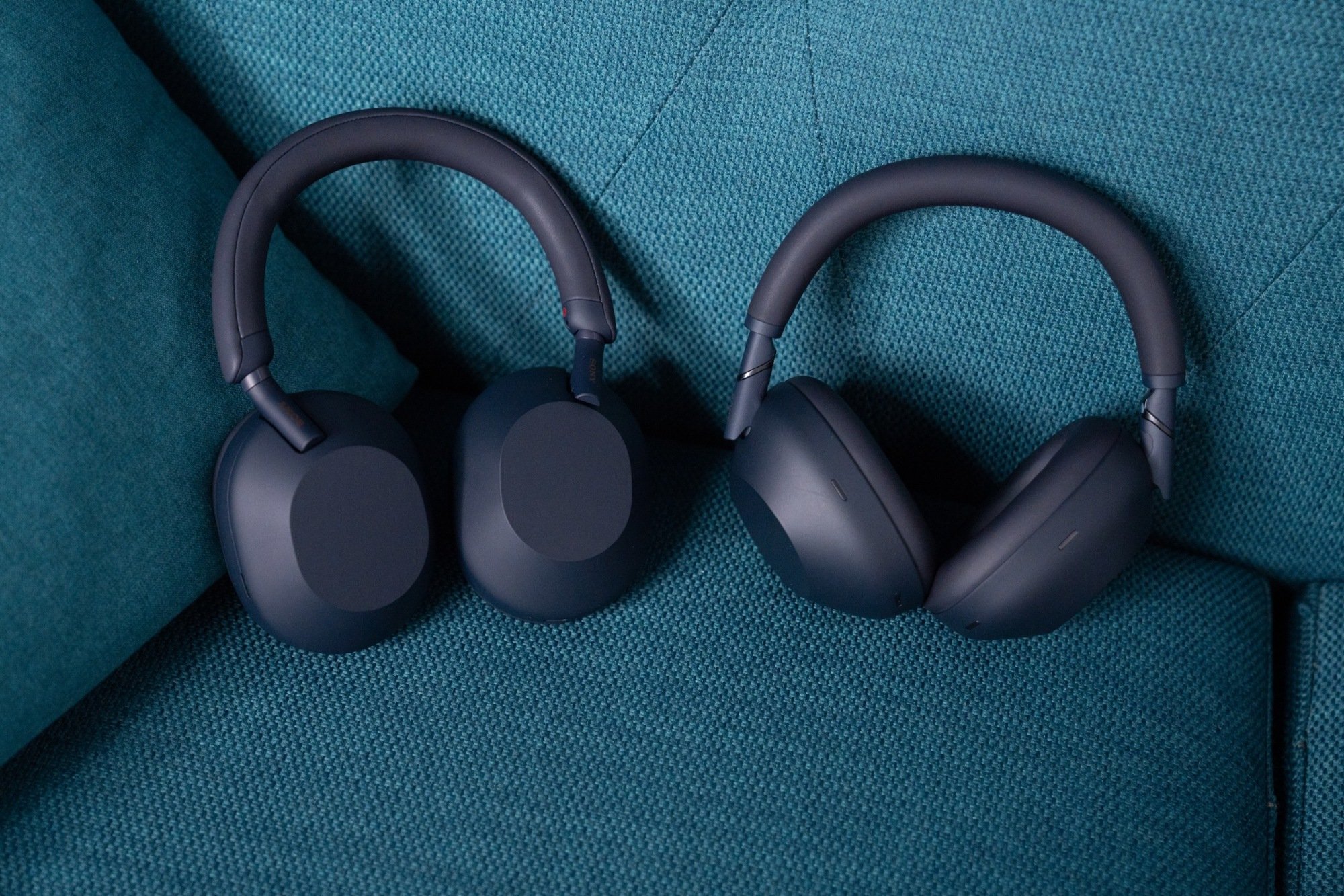 Sony xm6 and xm5 headphones next to each other on a couch