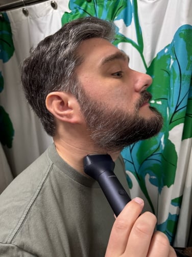 timothy beck werth, an incredibly handsome man with salt and pepper hair, shaving with the panasonic multishape