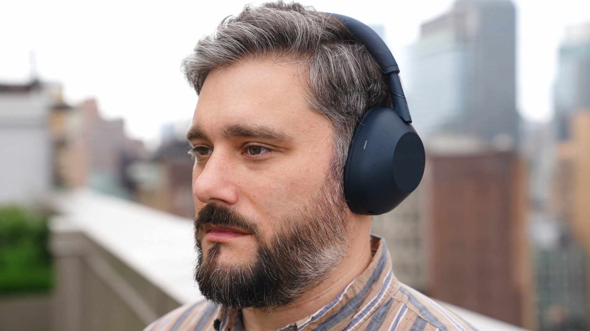 author wearing sony xm6 headphones outdoors