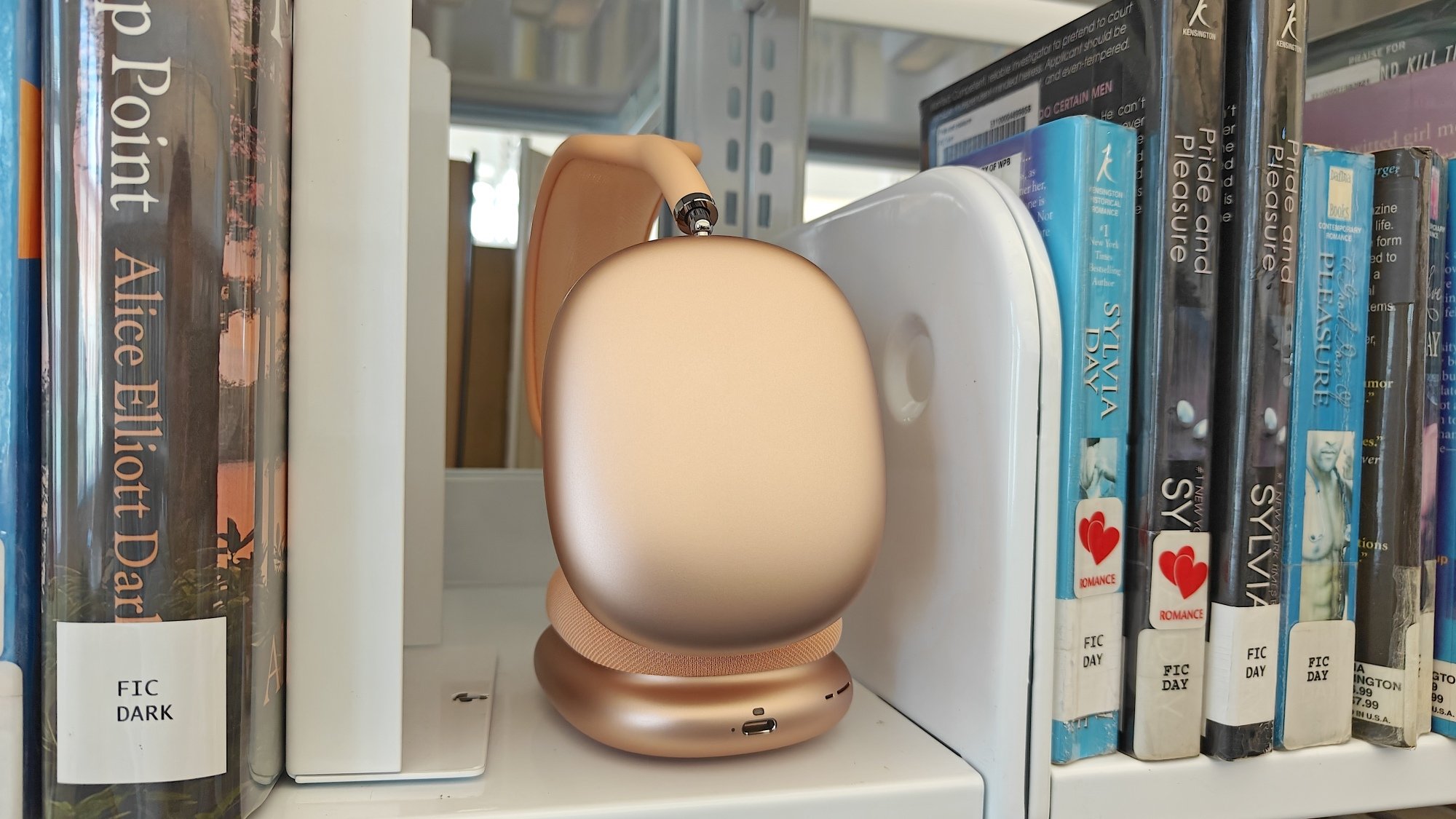 apple airpods max headphones on bookshelf