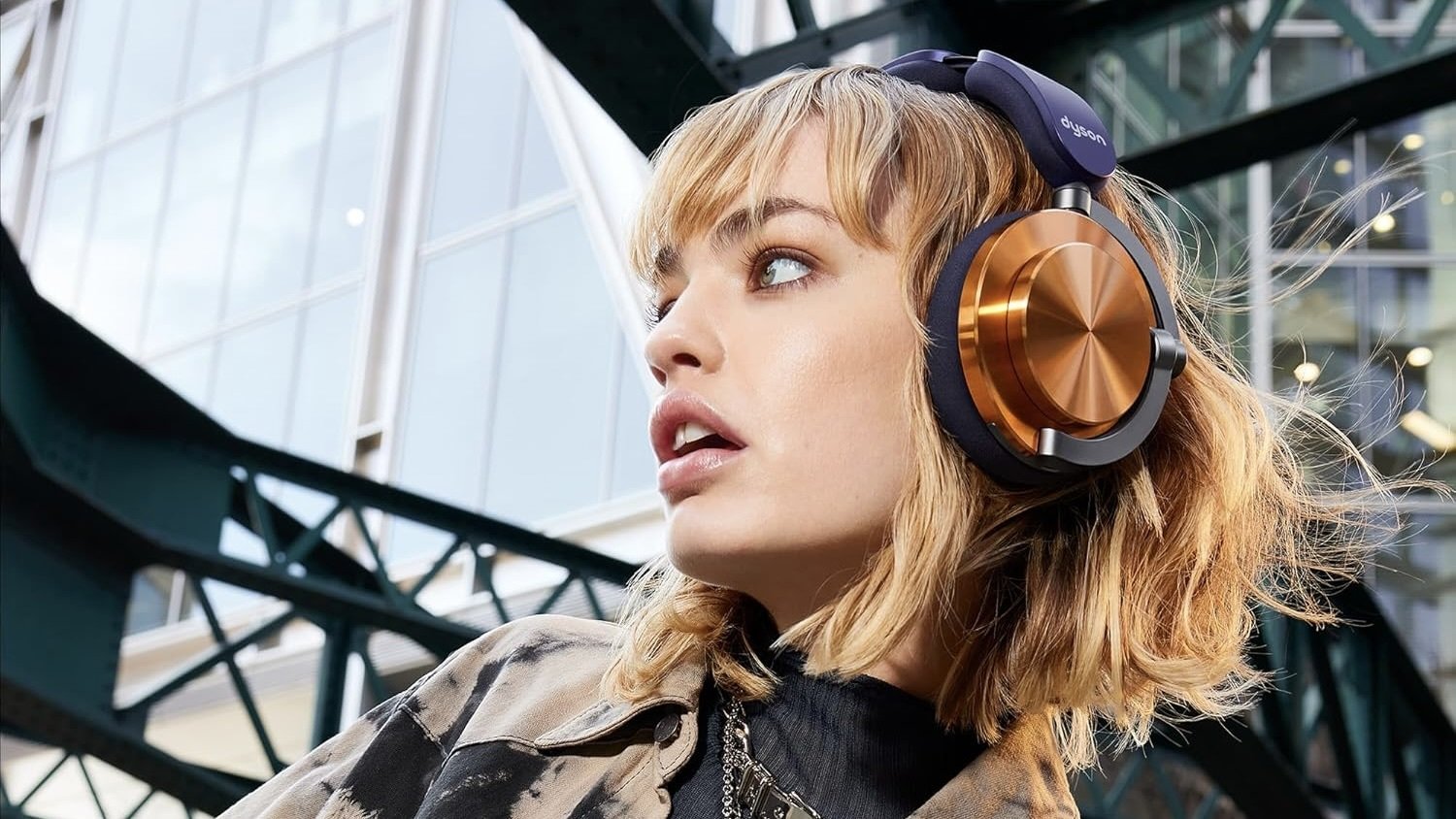 person wearing copper dyson ontrac headphones outdoors