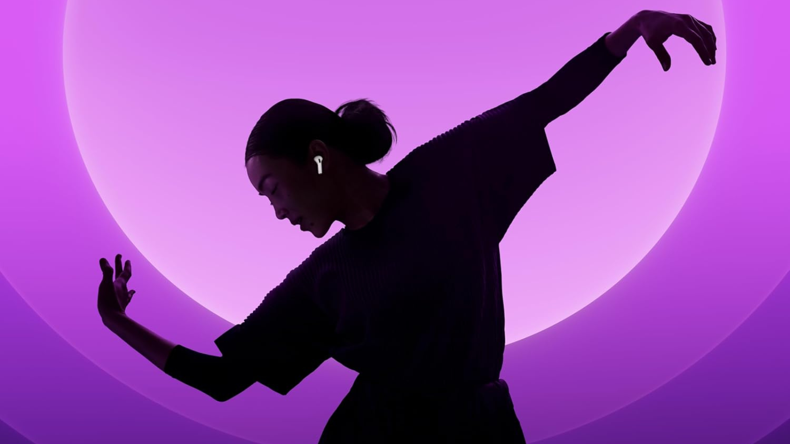 woman's silhouette dancing with airpods in against a purple background