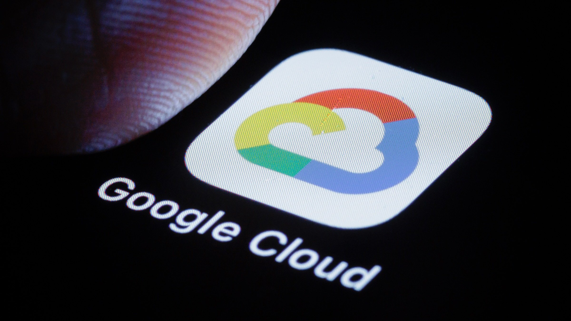 a google cloud logo under a thumb