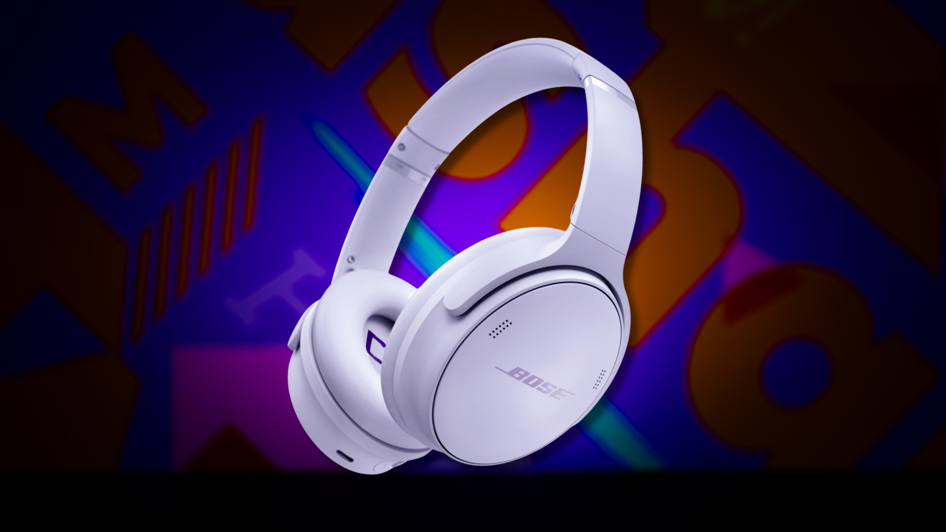A pair of Bose QuietComfort headphones on a colorful background