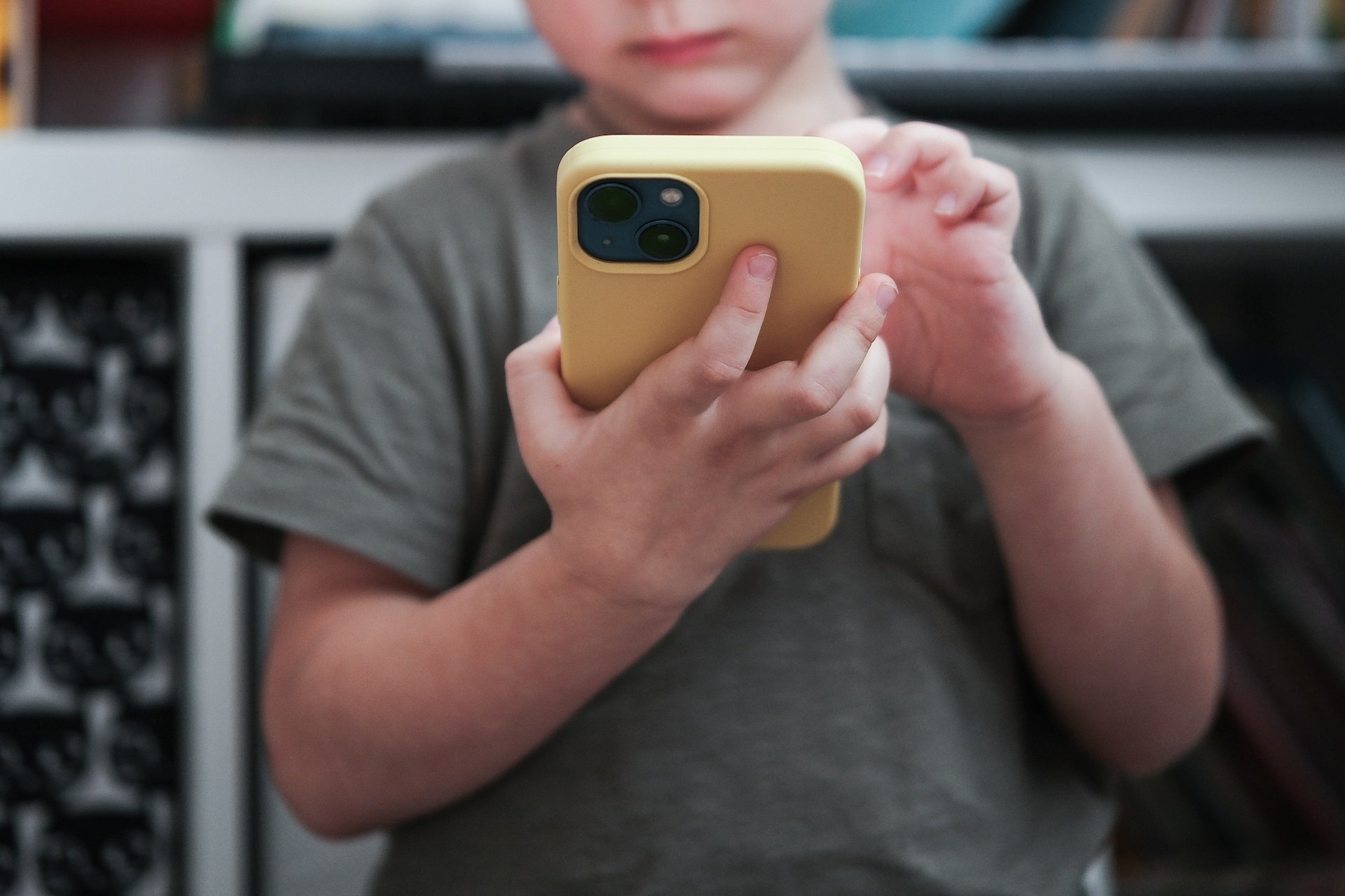 A child looks at a smartphone.