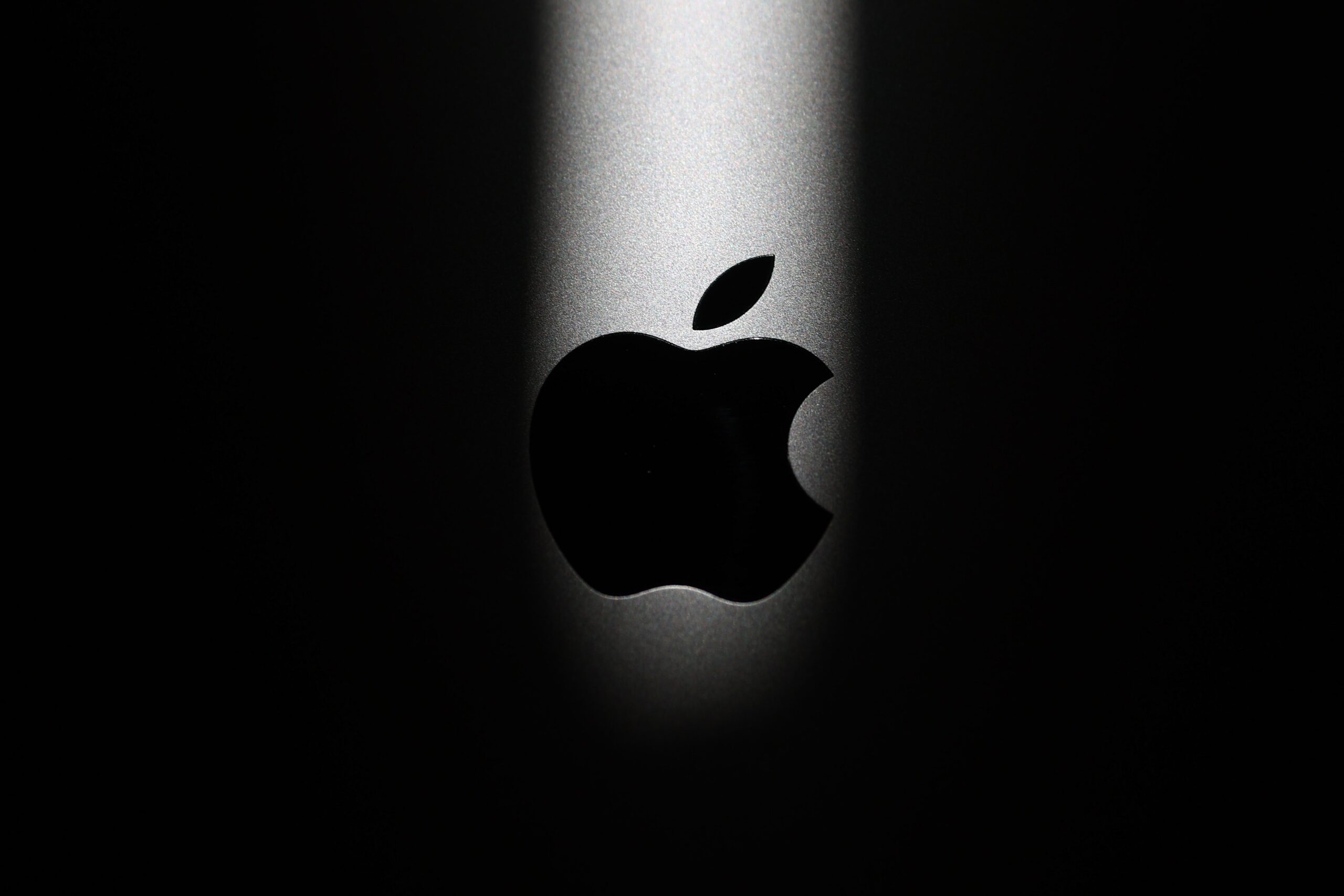 apple logo in a spotlight