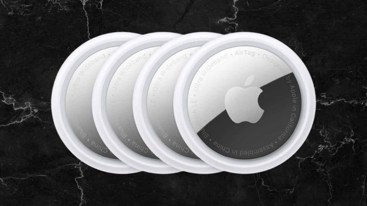 The Apple AirTag 4-Pack on a black background
