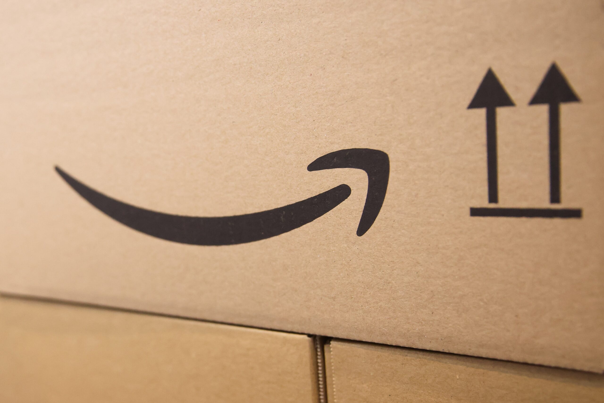 The Amazon smile logo on a brown cardboard box. 
