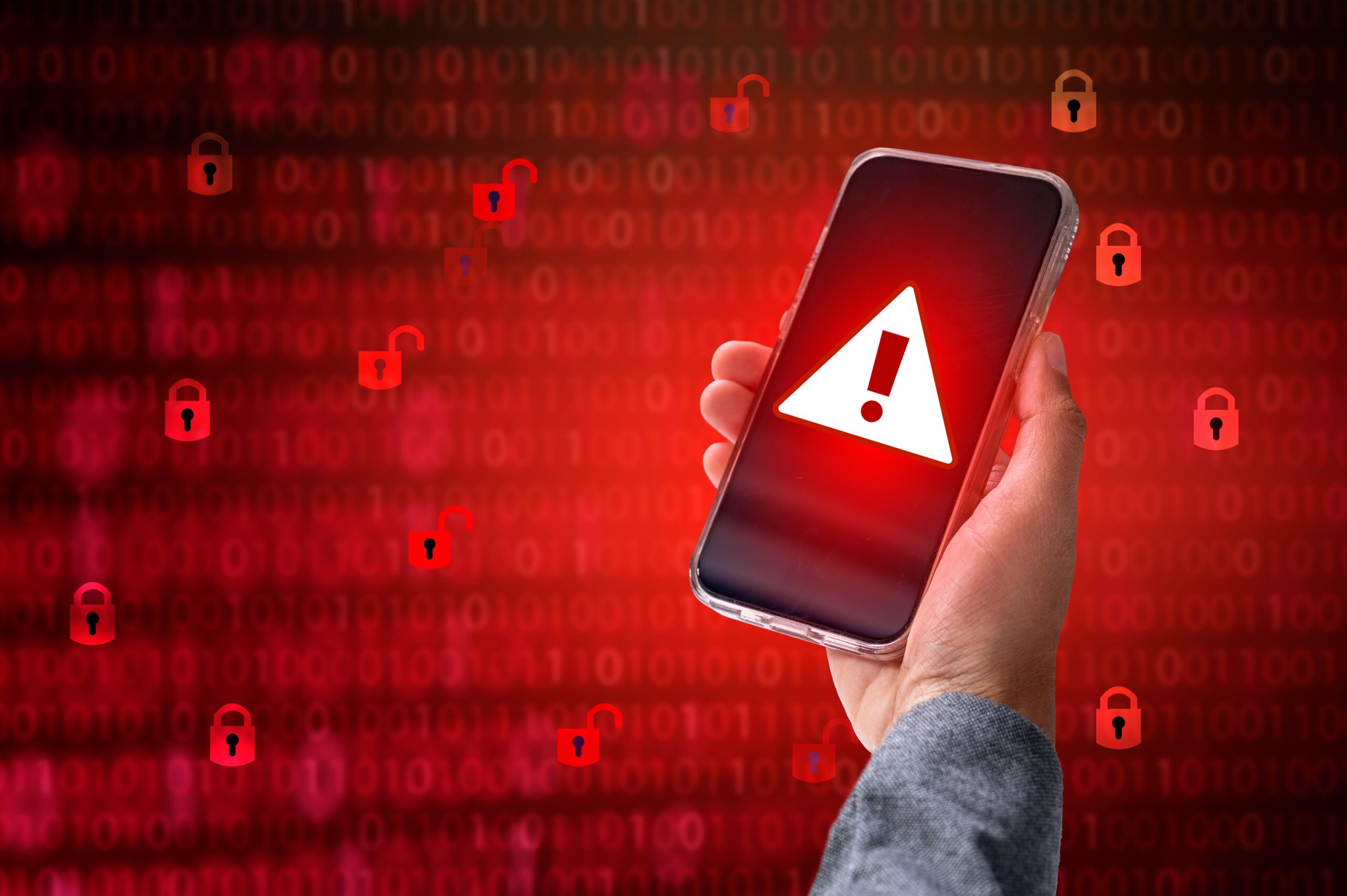 Hacker in a blue hoody standing in front of a coding background with binary streams and information security terms cybersecurity concept