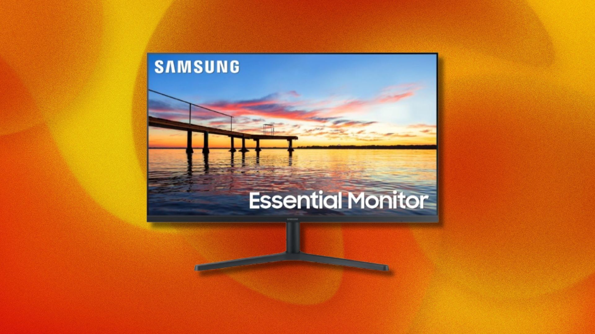 a samsung essential monitor on an orange background with orange shapes