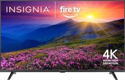 An Insignia TV appears on a white background with a sunset over a mountain depicted on its screen.