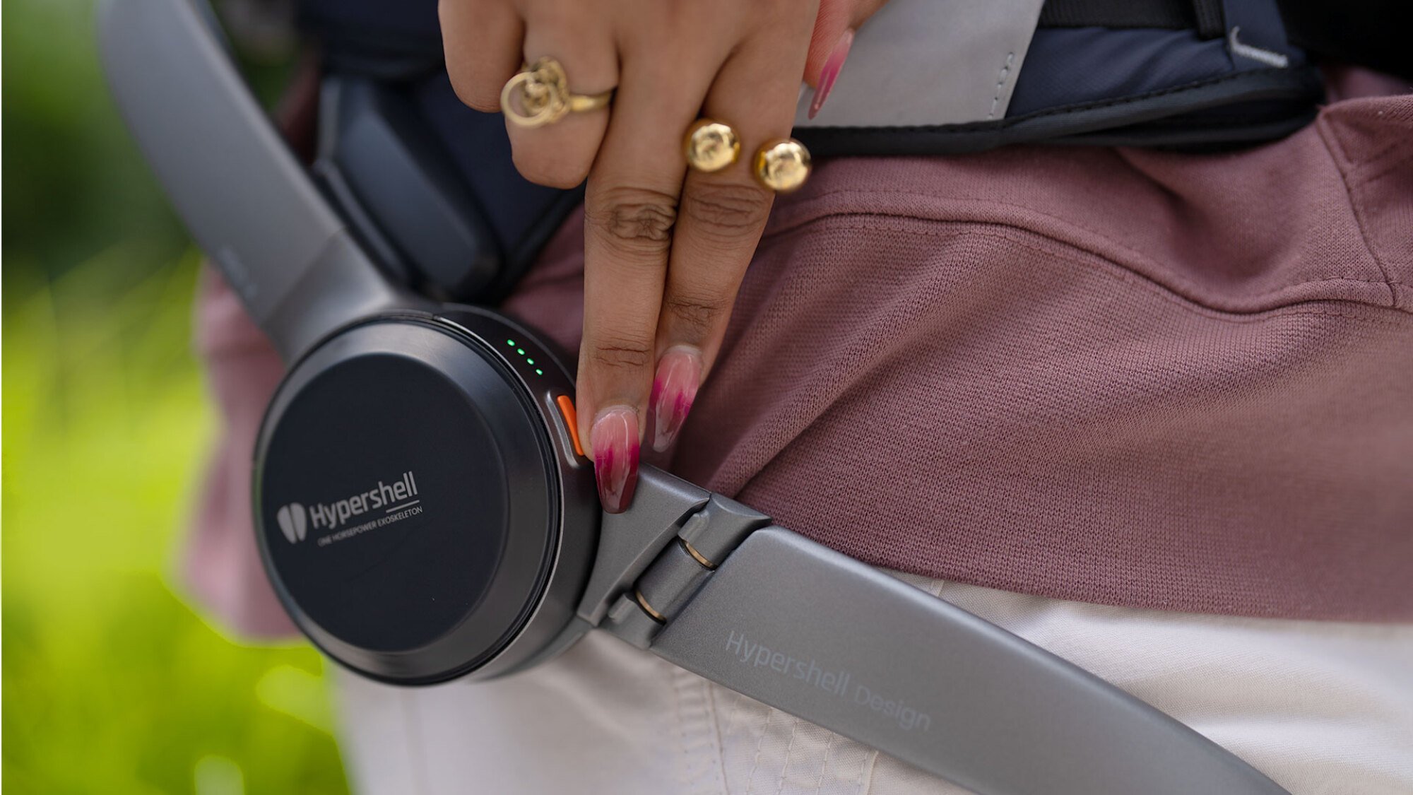 Hiker powering on the Hypershell device using power button