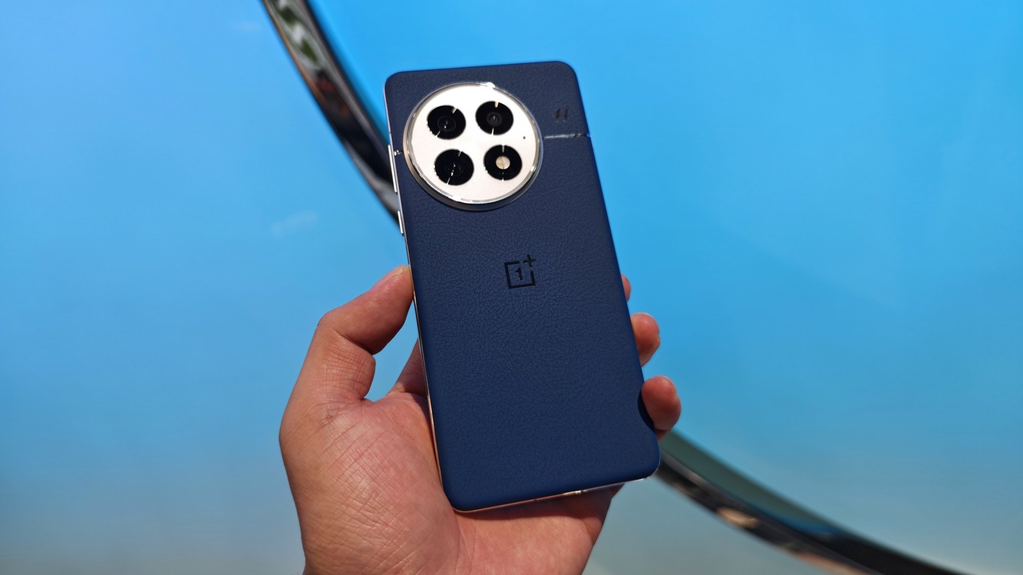 A visitor tries OnePlus 13 smartphone at OnePlus's new product launch event