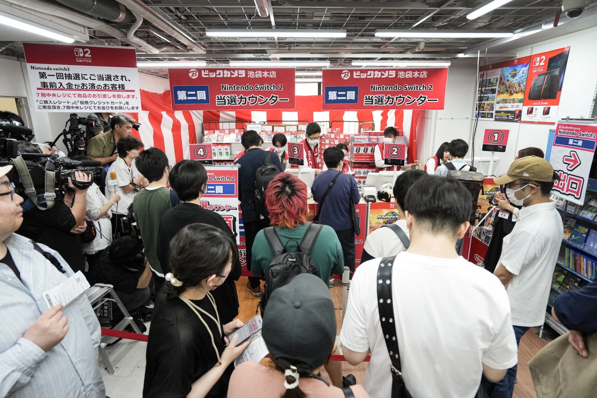 Customers wait in line in an electronics retailer in Tokyo, Japan.