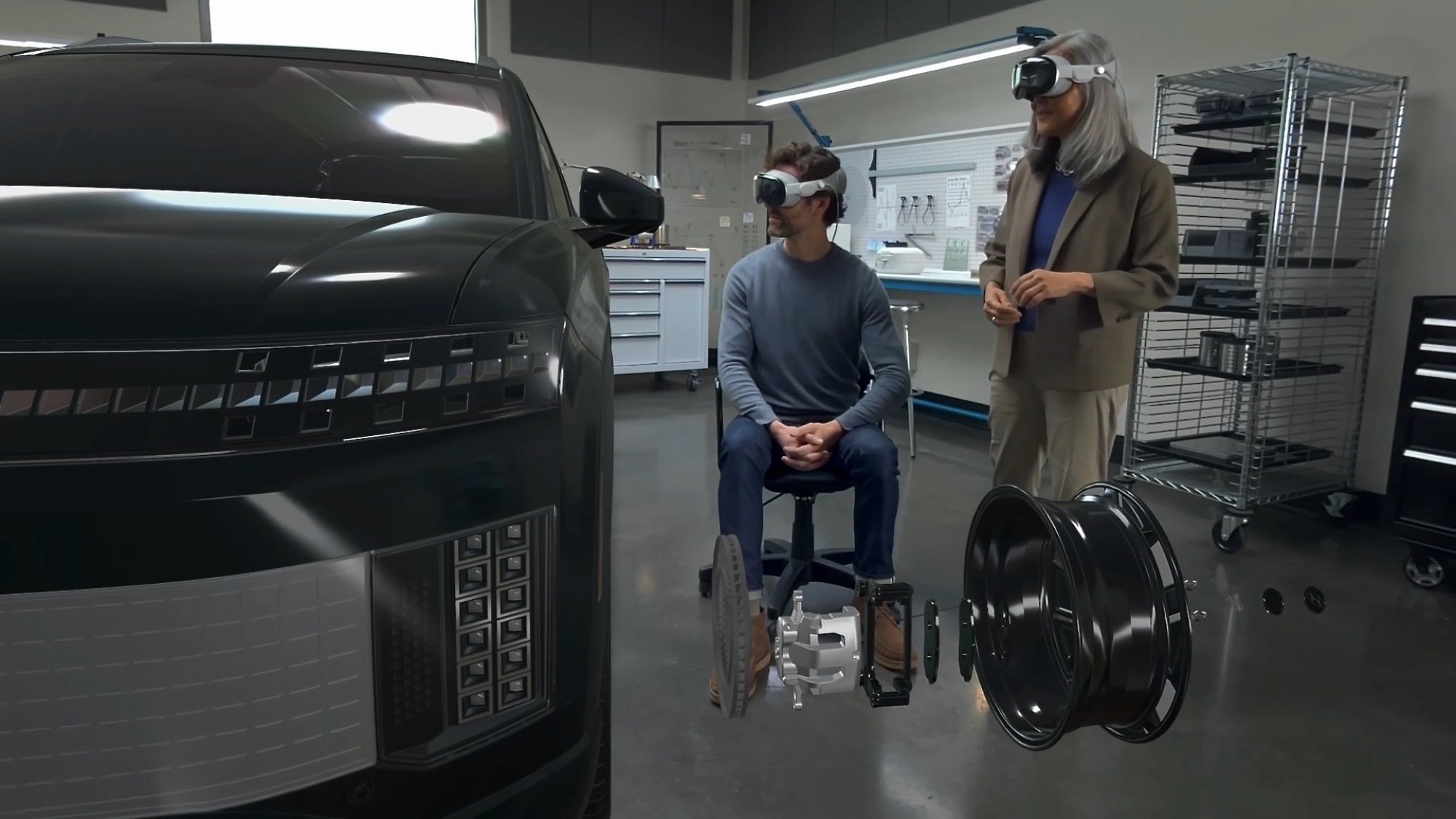two people in a garage using apple vision pro headsets