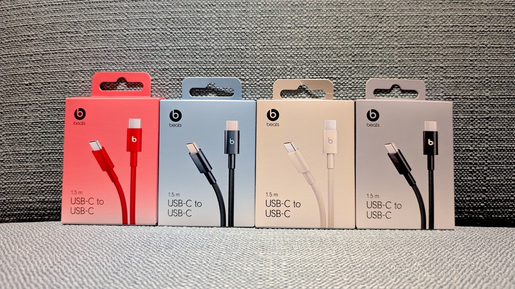 four boxes of beats charging cables in different colors