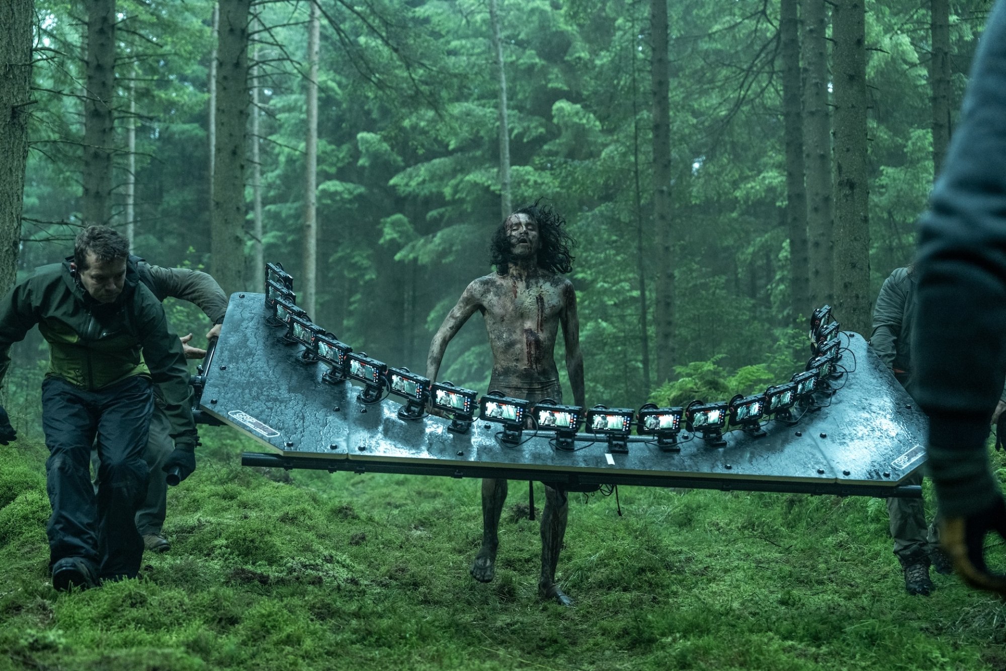 A behind-the-scenes photo from "28 Years Later" showing a zombie surrounded by an iPhone rig.