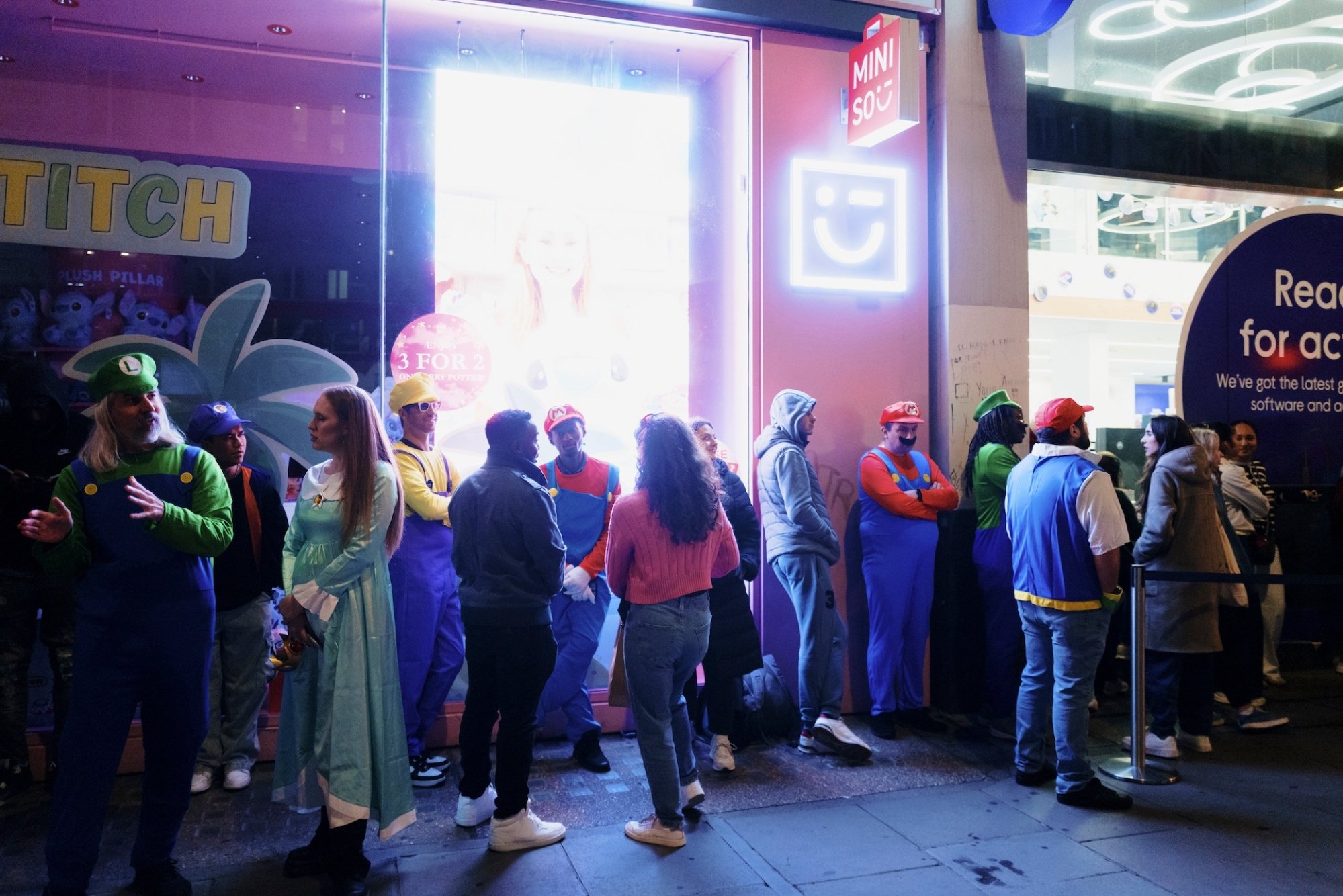 Customers wait in line outside a Currys Plc store on Oxford Street in London, UK.