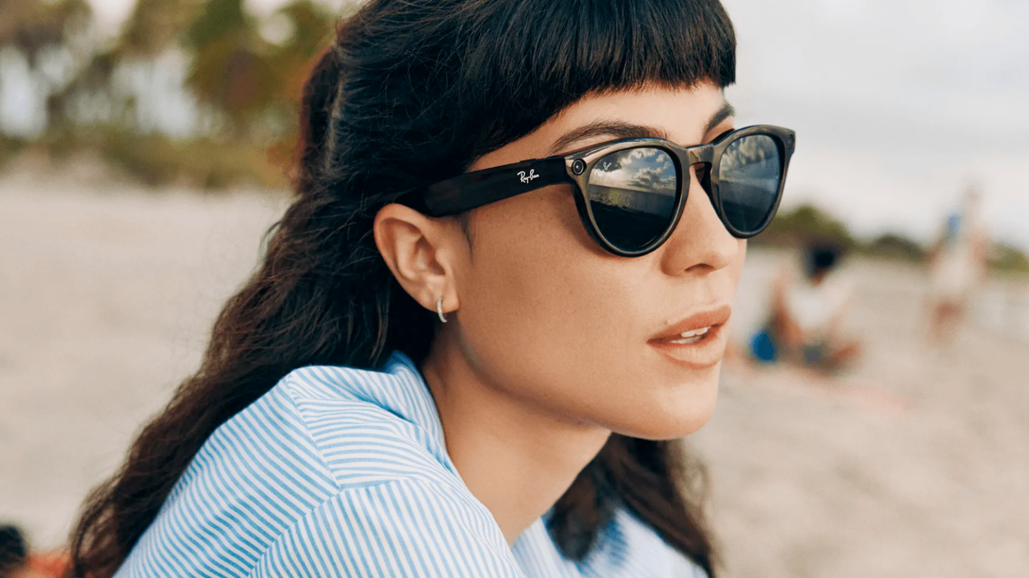 A woman wearing the Ray-Ban Meta smart glasses as sunglasses.