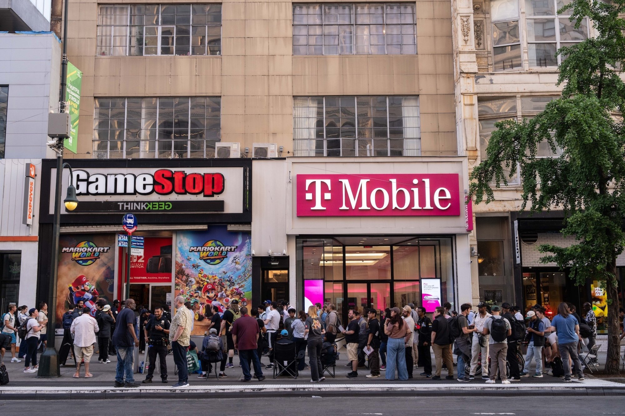 Customers wait in line outside a GameStop in New York City.