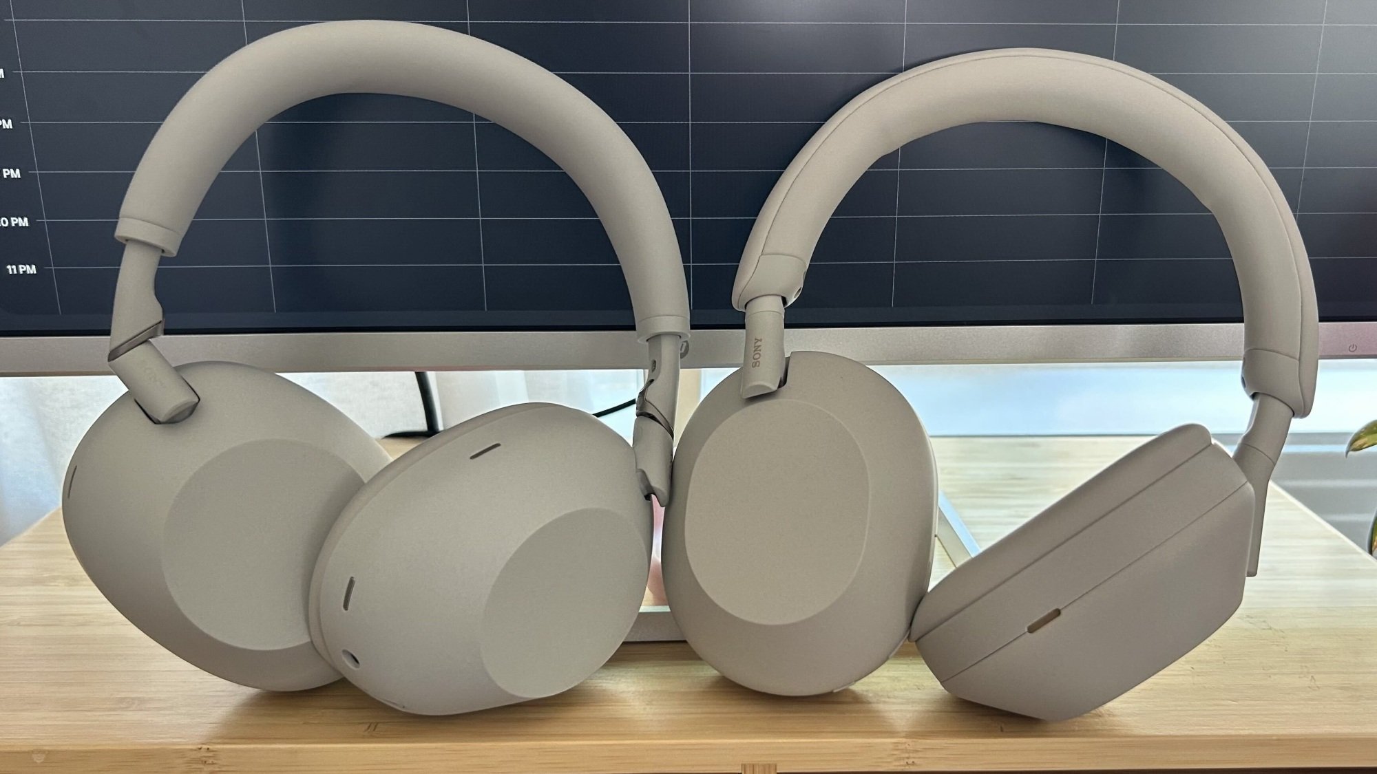 sony headphones propped against computer monitor
