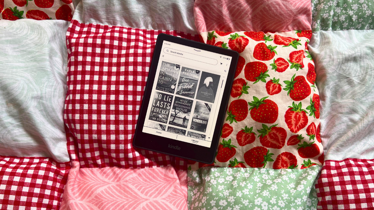 Kindle Paperwhite with screen open to library sitting on a quilt