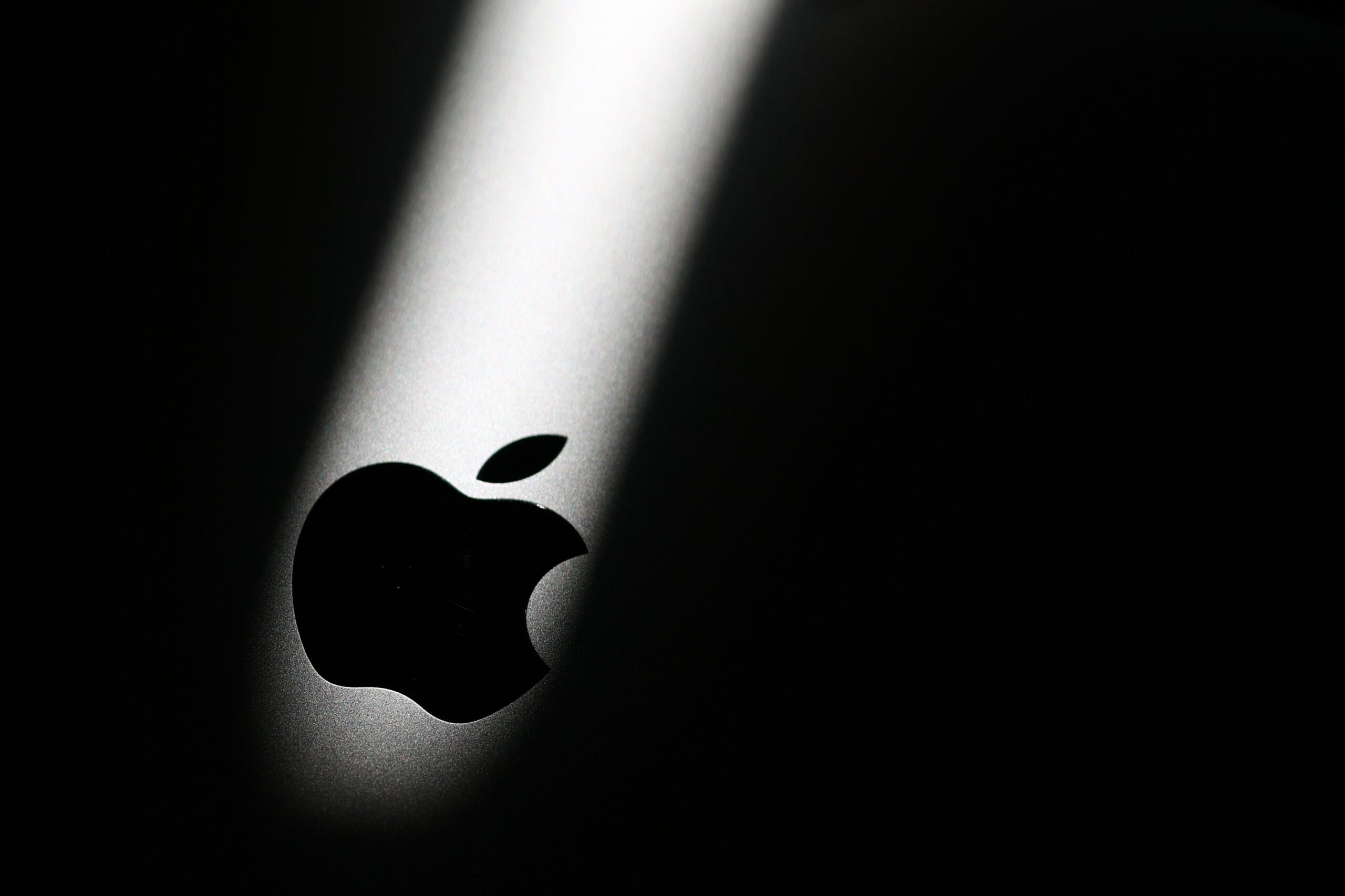 Apple logo is seen on MacBook in this illustration photo