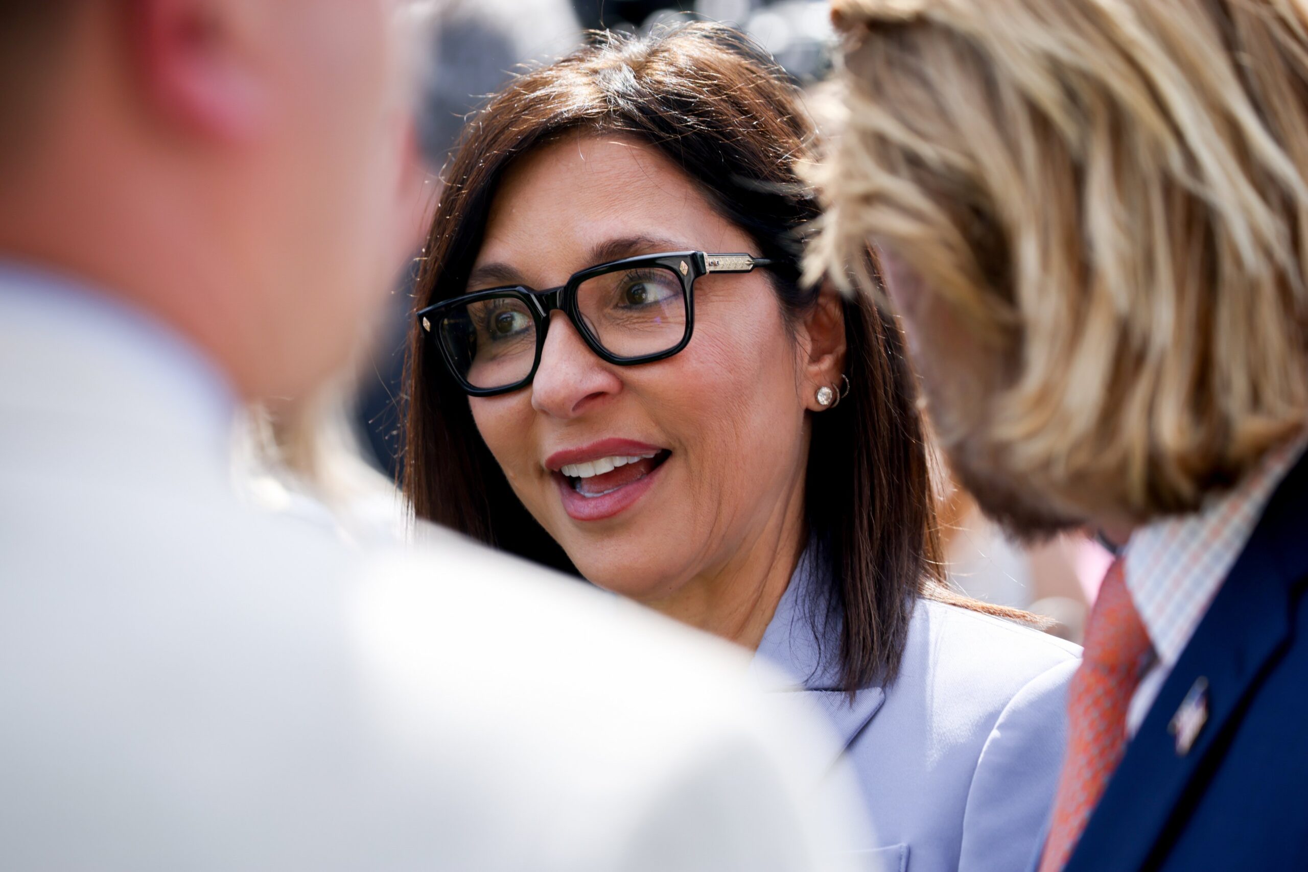 A close shot of Yaccarino talking to a group of people in the White House Rose Garden.