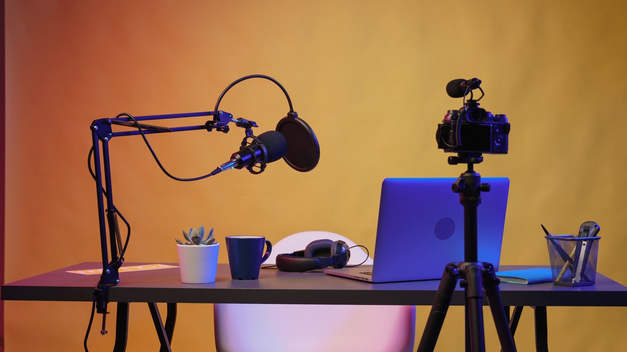 a microphone, tripod and camera in home studio