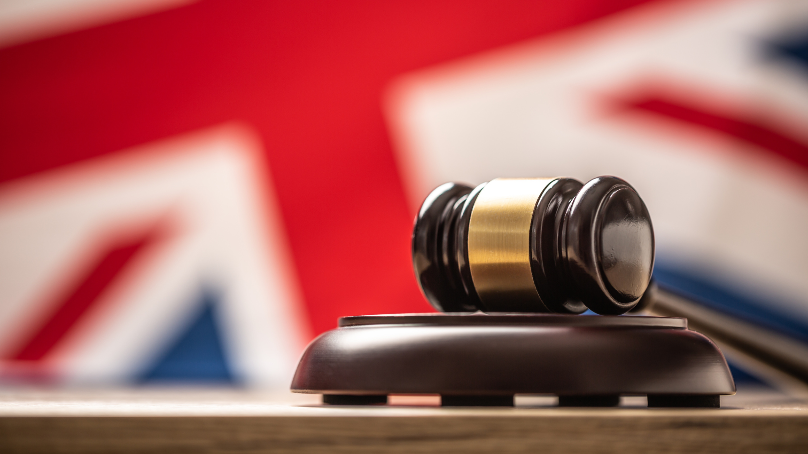 a gavel in front of a british flag